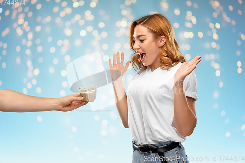 Image of happy couple in white t-shirts with christmas gift