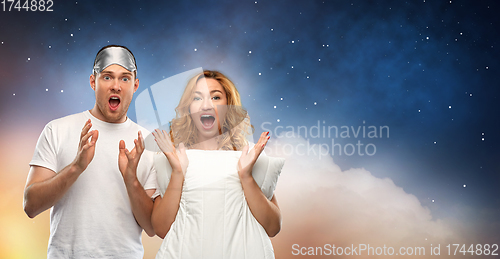 Image of couple with eye sleeping mask and pillow at night