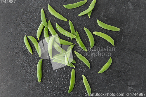 Image of peas on wet slate stone background