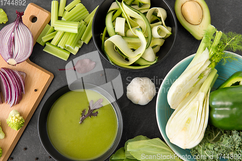 Image of green vegetables and cream soup in ceramic bowl