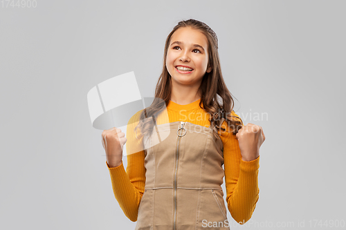 Image of happy young teenage girl celebrating success