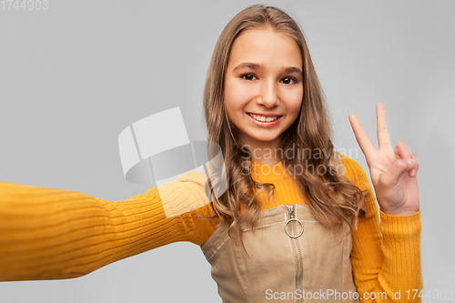 Image of happy teenage girl taking selfie