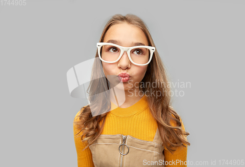 Image of teenage student girl in glasses making faces