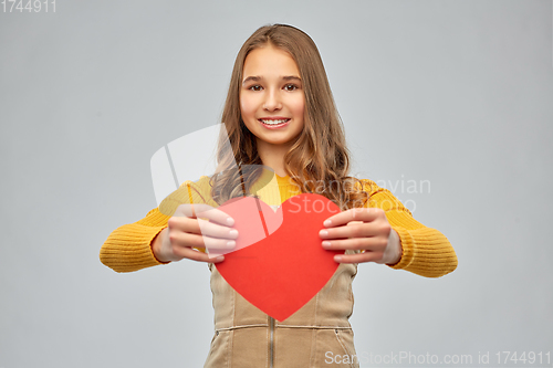 Image of smiling teenage girl with red heart