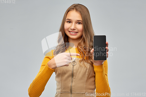Image of smiling teenage girl showing smartphone