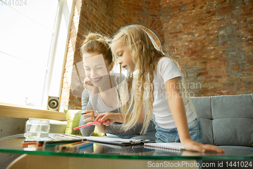 Image of Teacher and little girl, or mom and daughter. Homeschooling concept