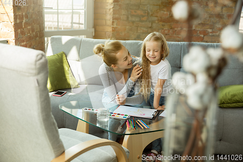 Image of Teacher and little girl, or mom and daughter. Homeschooling concept