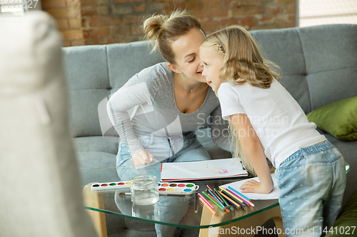 Image of Teacher and little girl, or mom and daughter. Homeschooling concept