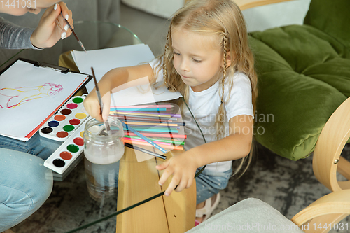 Image of Teacher and little girl, or mom and daughter. Homeschooling concept