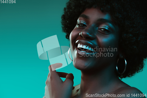 Image of Portrait of female high fashion model in neon light
