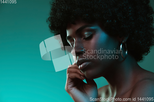 Image of Portrait of female high fashion model in neon light