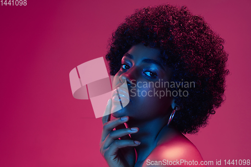 Image of Portrait of female high fashion model in neon light