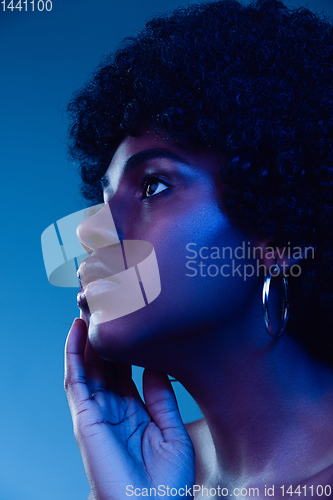 Image of Portrait of female high fashion model in neon light