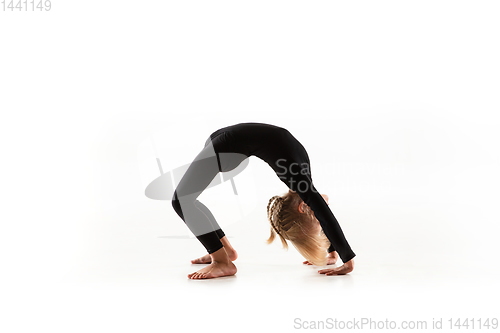 Image of Female little gymnast practicing isolated on white background