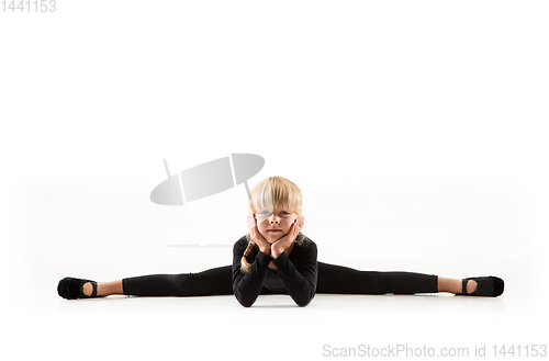 Image of Female little gymnast practicing isolated on white background