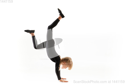 Image of Female little gymnast practicing isolated on white background