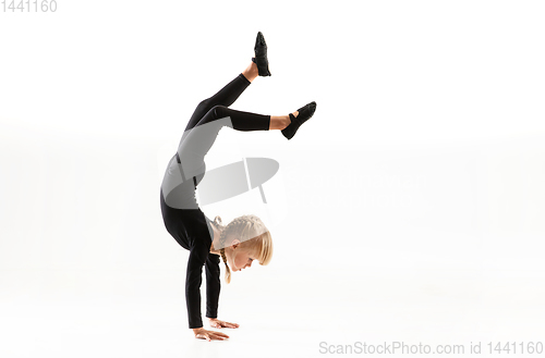 Image of Female little gymnast practicing isolated on white background