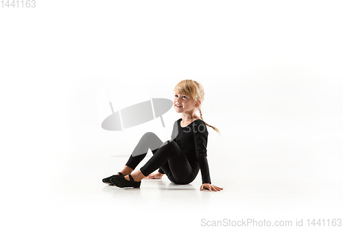 Image of Female little gymnast practicing isolated on white background