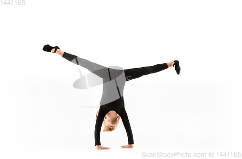 Image of Female little gymnast practicing isolated on white background