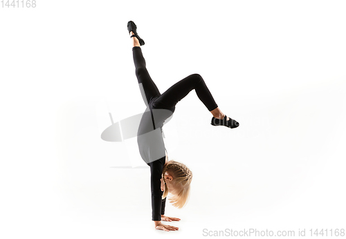 Image of Female little gymnast practicing isolated on white background