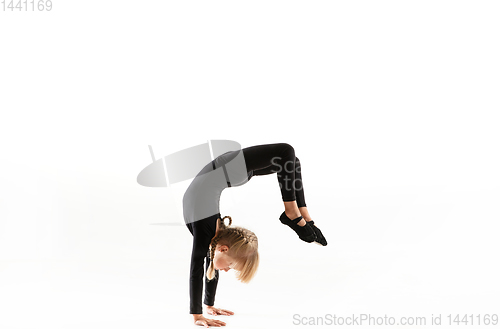 Image of Female little gymnast practicing isolated on white background