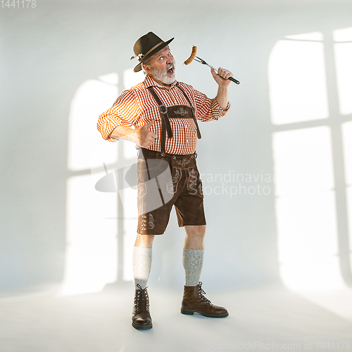 Image of Portrait of Oktoberfest man, wearing the traditional Bavarian clothes