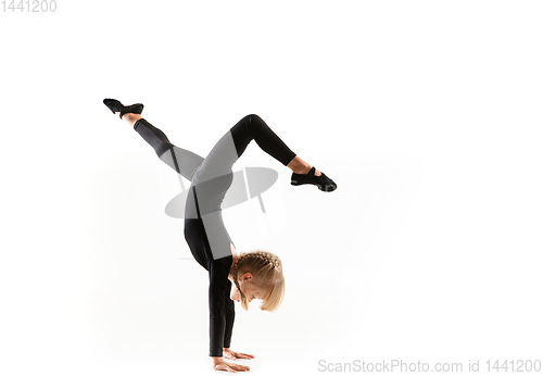 Image of Female little gymnast practicing isolated on white background