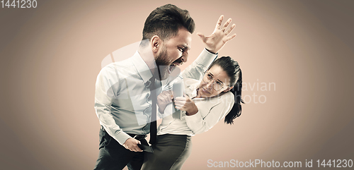 Image of Angry business man screaming at employee in the office