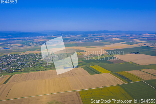 Image of Aerial view of summer fields and village