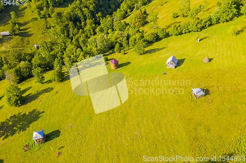 Image of Aerial view of pasture and haystacks