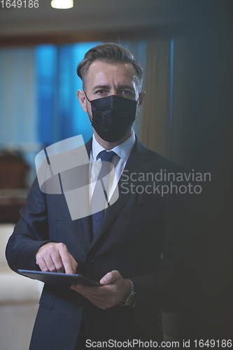 Image of business man wearing protective face mask at office