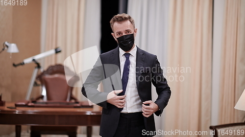 Image of business man wearing protective face mask at office