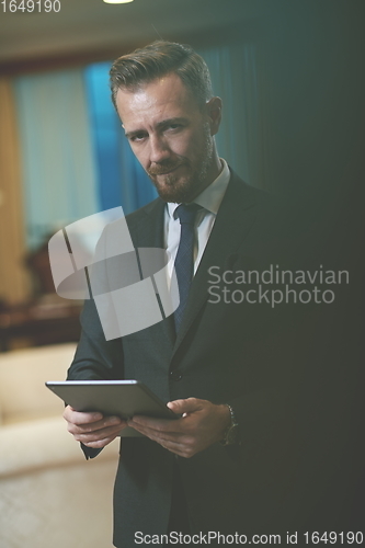 Image of business man using tablet computer