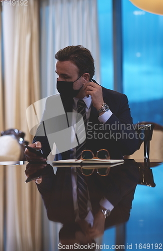 Image of business man wearing protective face mask at office