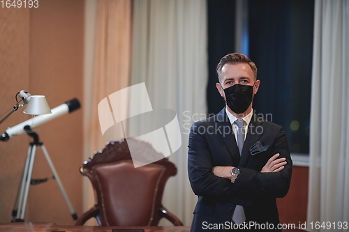 Image of business man wearing protective face mask at office