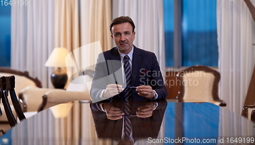 Image of corporate businessman at luxury office pen holding 