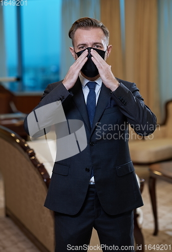 Image of business man wearing protective face mask at office