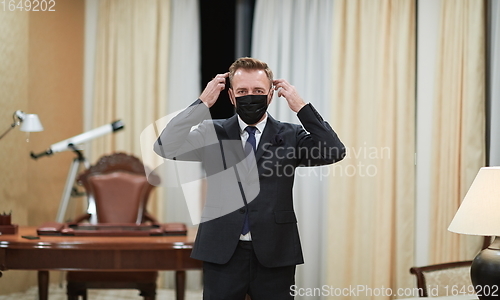 Image of business man wearing protective face mask at office