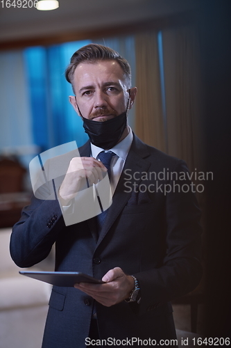 Image of business man wearing protective face mask at office