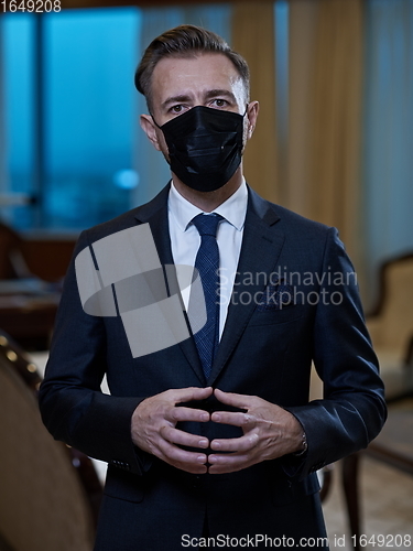 Image of business man wearing protective face mask at office