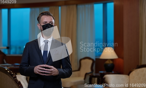 Image of business man wearing protective face mask at office
