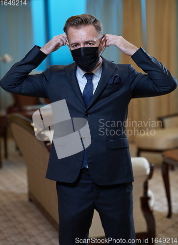 Image of business man wearing protective face mask at office