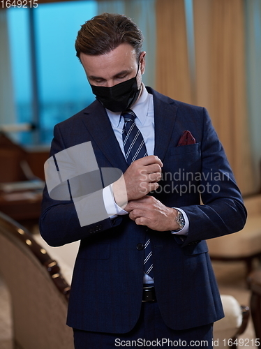 Image of business man wearing protective face mask at office