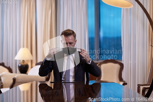 Image of business man wearing protective face mask at office