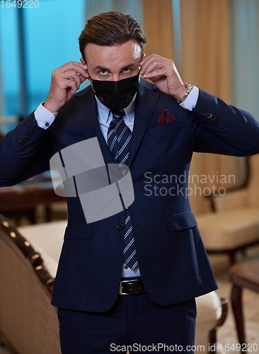 Image of business man wearing protective face mask at office