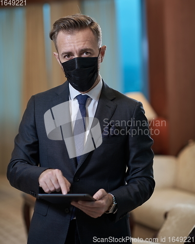 Image of business man wearing protective face mask at office