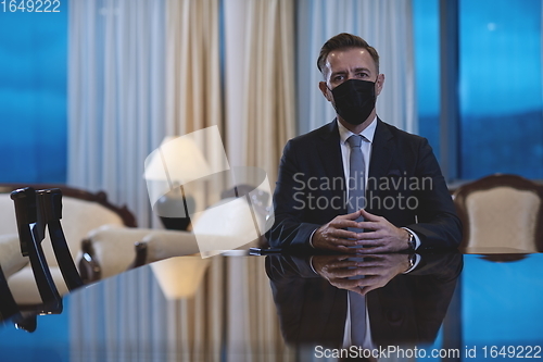 Image of business man wearing protective face mask at luxury office