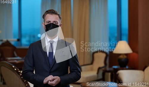 Image of business man wearing protective face mask at office