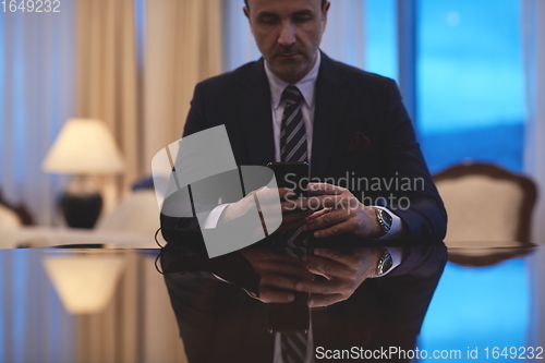 Image of business man using smart phone at luxury office