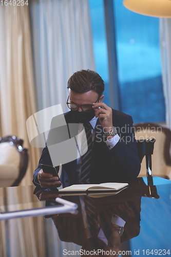 Image of business man wearing protective face mask at office